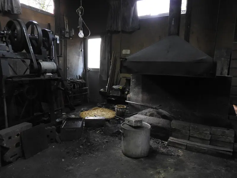 Interior of a Japanese blacksmith’s forge with power hammer and hearth